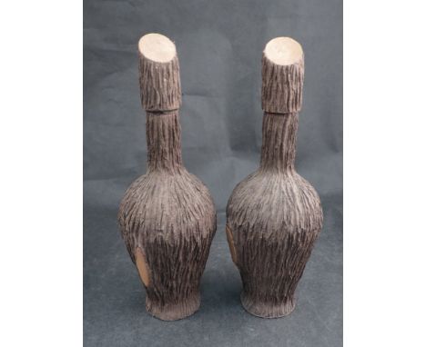 A pair of vintage bark covered bottles 