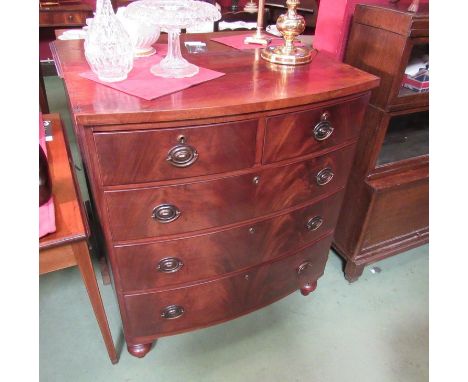 A circa 1940 flame mahogany bow front chest of two short over three graduating long drawers on turned feet