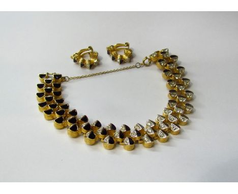 A costume bracelet with black enamel and diamanté decoration with a pair of matching earrings