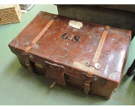 A vintage brown leather travelling trunk with original straps and key 