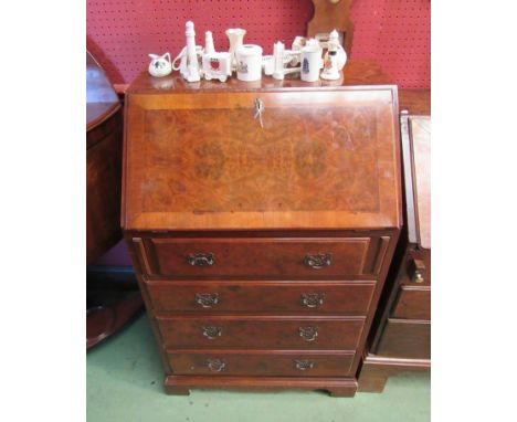 A walnut bureau with four graduating drawers, on bracket feet 