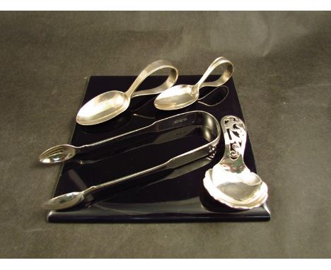 A pair of silver sugar tongs, two silver feeding spoons and a silver caddy spoon, various makers and assays, 115g