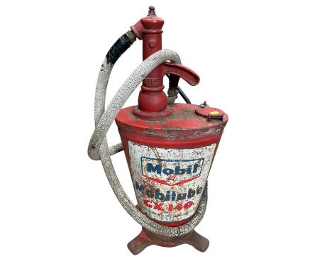 Vintage red painted gear oil dispenser with Mobil branding.