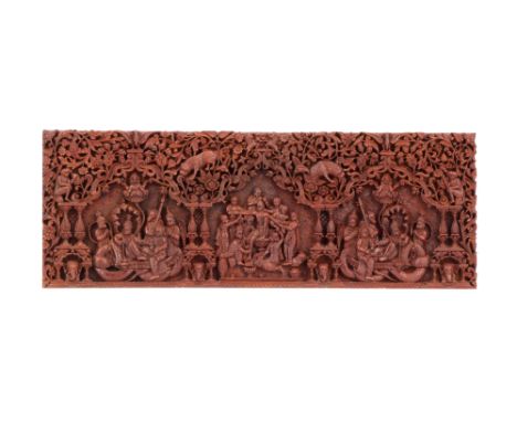 An Early 20th Century Sri Lankan Plaque, with finely detailed shallow relief scenes of deities amidst temple columns, beneath
