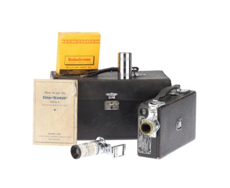 A Cine Kodak Model K Cine Camera, black, motor running, with shot film on spool, also with a Kodak Anastigmat f/1.9 25mm lens