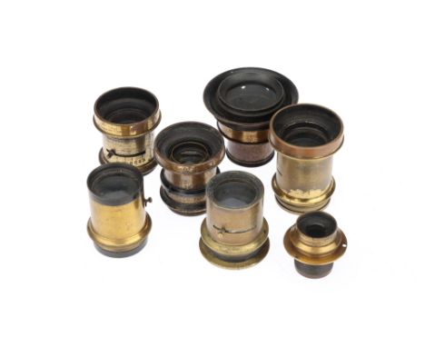 A Collection of Seven Brass Camera Lenses, most unmarked and require attention (a lot)