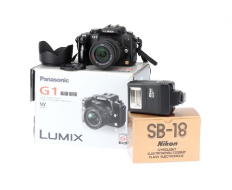 A Panasonic Lumix G1 Digital Camera, with Panasonic G Vario f/3.5-5.5 14-45mm lens, body, very lightly sticky, but powers up 