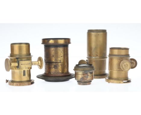 Five Brass Lenses, to include a large unmarked brass lens with space for Waterhouse stops, a smaller brass lens with rotating