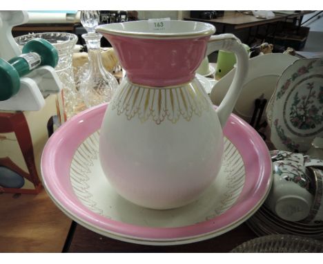 A large wash jug and bowl set in a pink and gold design