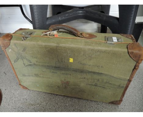 A canvas bound travel trunk or suitcase