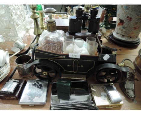 A selection of mens trinkets including binoculars drinks caddy and cigarette lighters