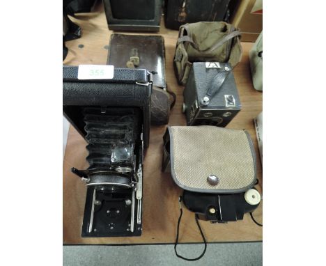 A Carbine folding camera, a Kodak Brownie 127, and a six-20 portrait Brownie 