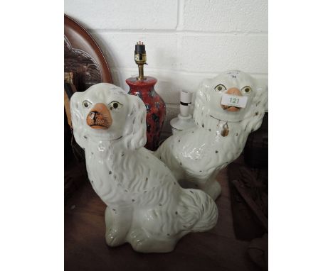 A pair of ceramic Staffordshire flatback dog figures