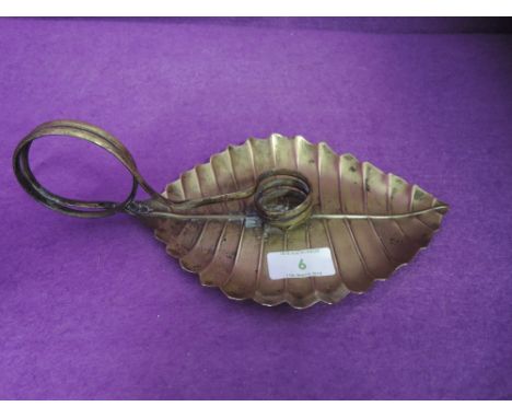 An arts and crafts candle holder of chamber stick by Joseph Sankey in an unusual Beech leaf design 