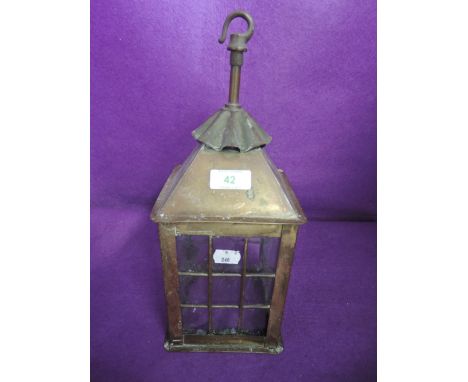 An arts and crafts style porch or similar outside light with brass body and cast glass 