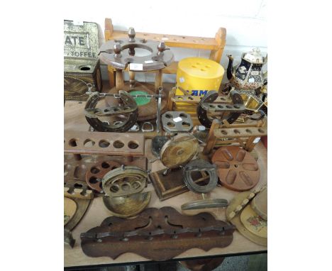 A selection of vintage tobacco smokers pipe racks and holders including ship's wheel design, farm gate and Camel ice bucket
