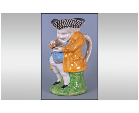 Staffordshire Late 18thC 'Snuff Taker' Toby Jug, brightly but simply coloured with yellow coat, pale blue waistcoat, black sh