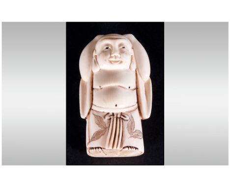 Japanese Late 19th Century Carved Ivory Netsuke In The Form Of A Man Standing with hands on head. Signed to underside of figu