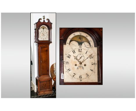 8 Day Oak Cased Grandfather Clock with an arched top rolling moon enameled dial, the hood with a shaped scroll pediment top w