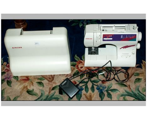 Singer Sewing Machine. Includes carry case, foot pedal and instruction manual. Not tested but appears to be in good condition