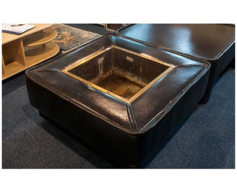 Contemporary Brown Leather Jardiniere with a central brass planter, supported on a stained wood skirt base.