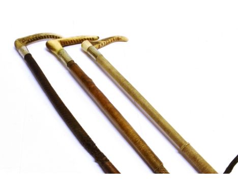 THREE GENT'S HUNTING WHIPS, one by Swaine, all with antler grips; one with leather shaft and two with plaited stafts, a two h