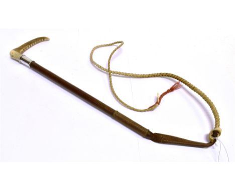 A LADY'S HUNTING WHIP by Swaine, with antler grip, silver collar and plaited leather shaft and leash