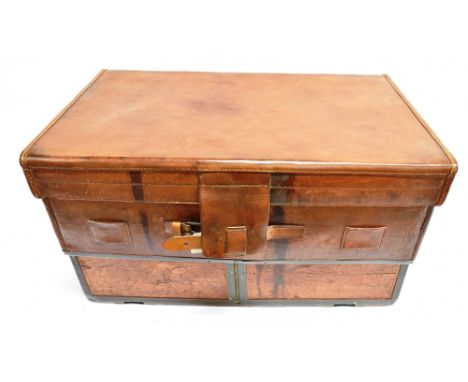 AN UNUSUAL EXPANDING RECTANGULAR LEATHER TRUNK operated from the interior by a longcase clock style key. The interior with gr