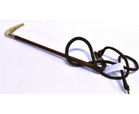 A LADY'S HUNTING WHIP, by Swaine with antler grip, silver collar and plaited leather shaft and leash