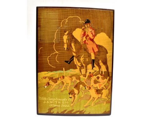 A MARQUETRY HUNTING SCENE PANEL depicting a mounted huntsman and house with painted inscription lower left 'with Compliments 