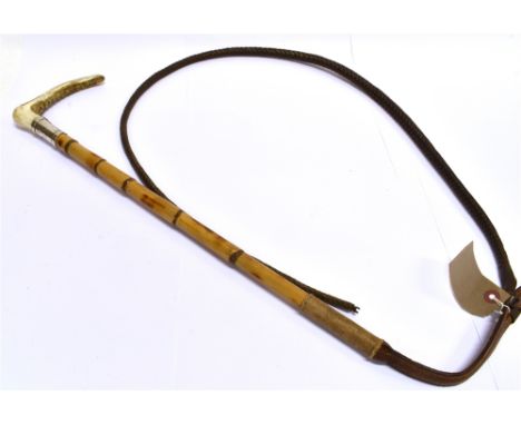 A HUNTING CROP  with antler grip, silver collar engraved 'P.L. Cazenove 1941', bamboo shaft and plaited leather leash