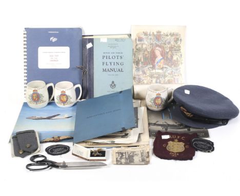 A collection of WWII and later items and manuals in a suitcase. Including a WWII pilots hat and epaulettes, Cadet University 