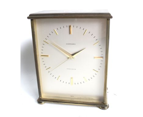 A mid-century Garrard Precision mantel clock. Swiss 21 jewel battery operated mechanism. Brass case, on bun feet.  Engraved '