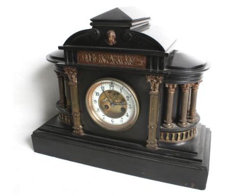 A 19th century French black slate mantel clock with columns. Ormolu architectural decoration, white dial, Arabic numerals and
