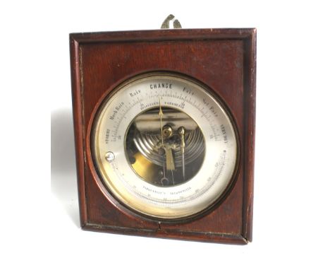 A cased aneroid wall barometer and thermometer. Diameter 13cm   Condition Report:  A brass cased 'Holosteric Barometer '  wit