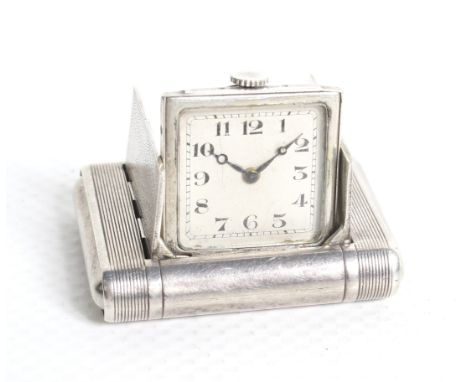 Art Deco circa 1930 silver travel clock. Engine turned case with hinged divided doors enclosing the hinged clock, inside of c