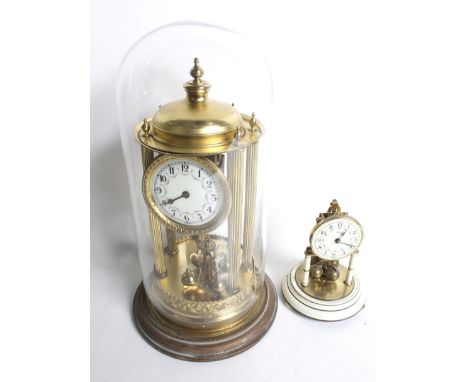 Two vintage German anniversary mantel clocks. Including a large portico, gilt metal on a circular base with a glass dome and 