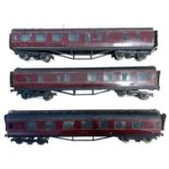 A trio of 0 gauge Basset Lowke LMS rail corridors in maroon livery. Some wear to paintwork and small