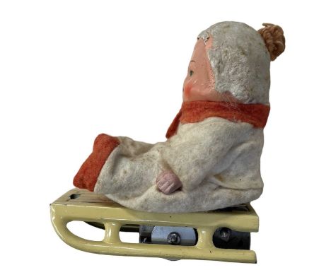 A vintage German clockwork toy modelled as a boy on a sledge.(lacking key)