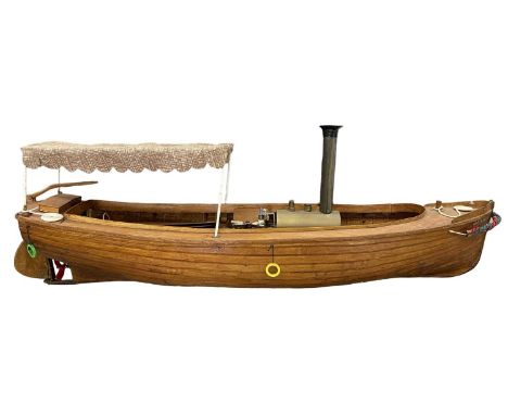 A scratchbuilt wooden steam boat model with canopy, 'Periwinkle', battery powered.Length approximately 92cm