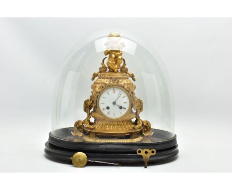 A LATE 19TH CENTURY FRENCH ORMOLU MANTEL CLOCK OF SHAPED CYLINDRICAL FORM, the circular top with seated cherub surmount above