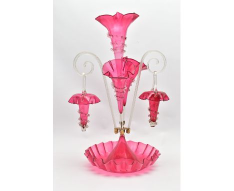 A VICTORIAN CRANBERRY AND CLEAR GLASS EPERGNE, the central trumpet with trailing decoration, enclosed by two smaller trumpets