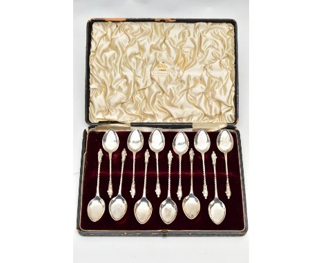 A CASED SET OF TWELVE EDWARDIAN SILVER ICE CREAM SPOONS, Elizabethan male figure finial on a spiral handle, makers Elkington 