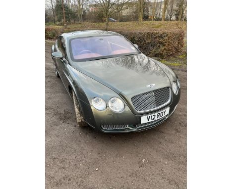 A BENTLEY CONTINENTAL GT AUTO COUPE CAR, with 'V12 ROY' private number plate, in silver with tan leather interior, first regi