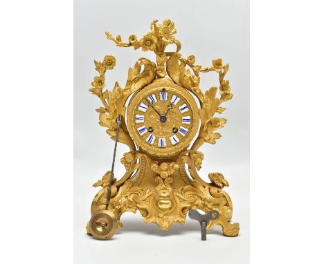 A LATE 19TH CENTURY FRENCH ORMOLU MANTEL CLOCK OF FOLIATE ROCOCO SCROLL DESIGN, the circular dial with blue and white enamel 