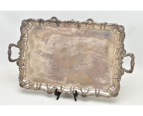 AN EDWARDIAN SILVER TWIN HANDLED TRAY OF RECTANGULAR FORM WITH PIE CRUST AND SHELL RIMS, plain surface, makers Deakin &amp; F