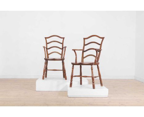 A set of eight vernacular elm and fruitwood chairs, 19th century, of Windsor type, each with an arched ladder back and open a