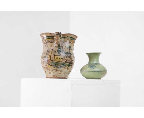 A painted and glazed terracotta pitcher, 19th century, Italian, with a trefoil mouth and loop handle, painted in greens and y