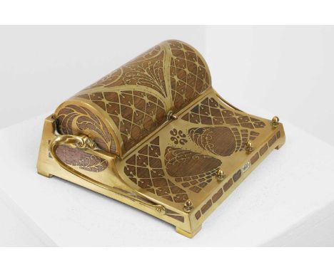 An Art Nouveau rosewood and brass-inlaid desk stand, fitted with a central hinged cover, enclosing two blue-glass-lined inkwe