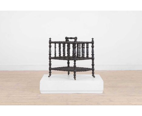 An ebonised wooden magazine rack,  c.1880, French, with bobbin-turned detail,  43cm wide 36cm deep 50cm high  Provenance: The